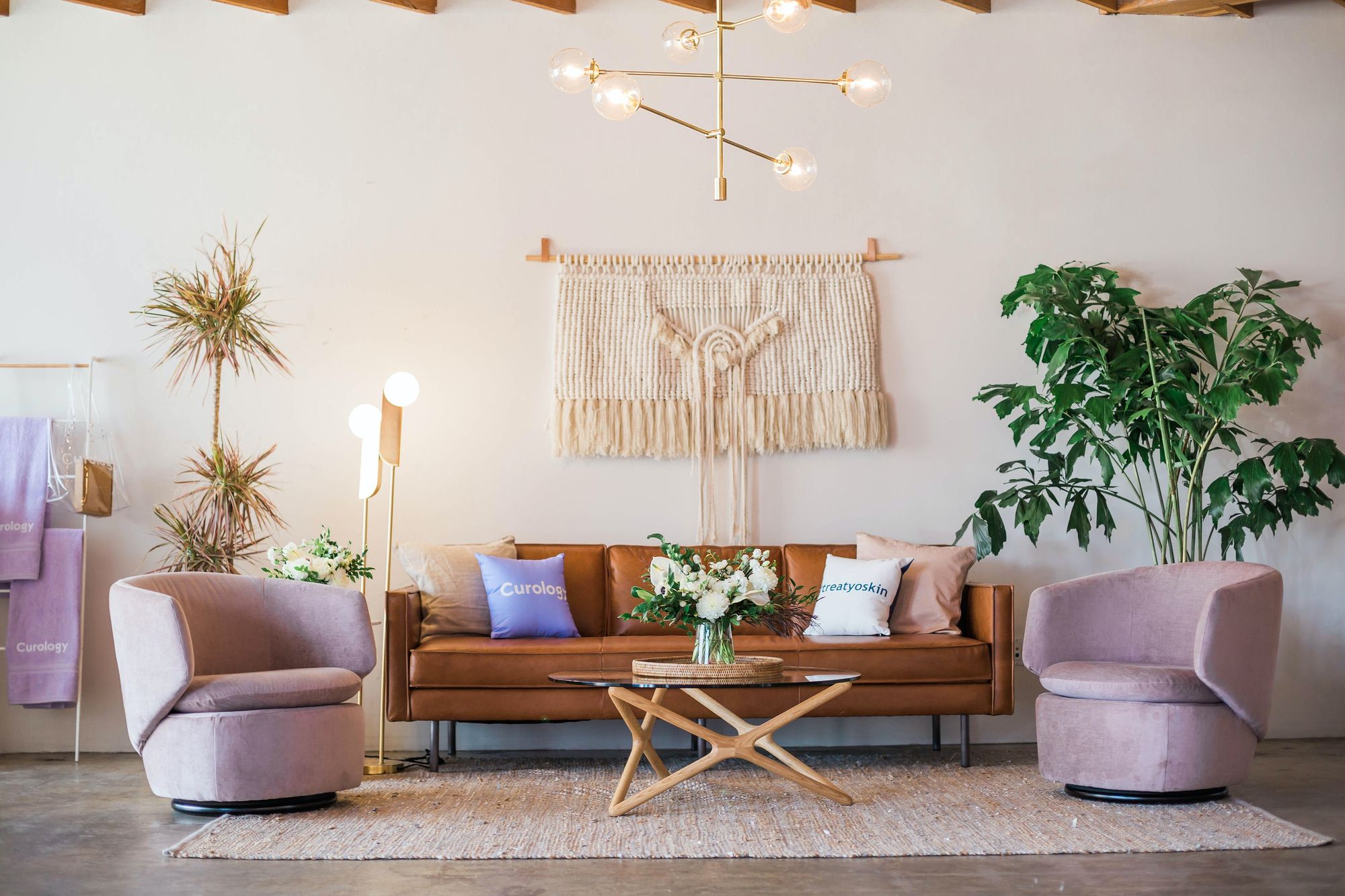 Colorful Boho living room with mix of patterns, textures, and greenery